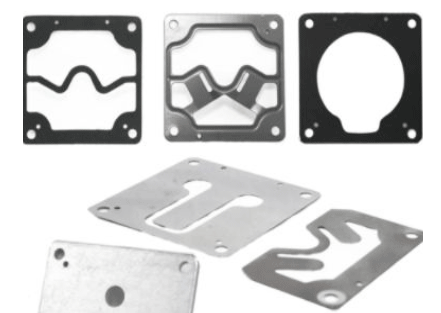 A selection of valve plates for various compressors